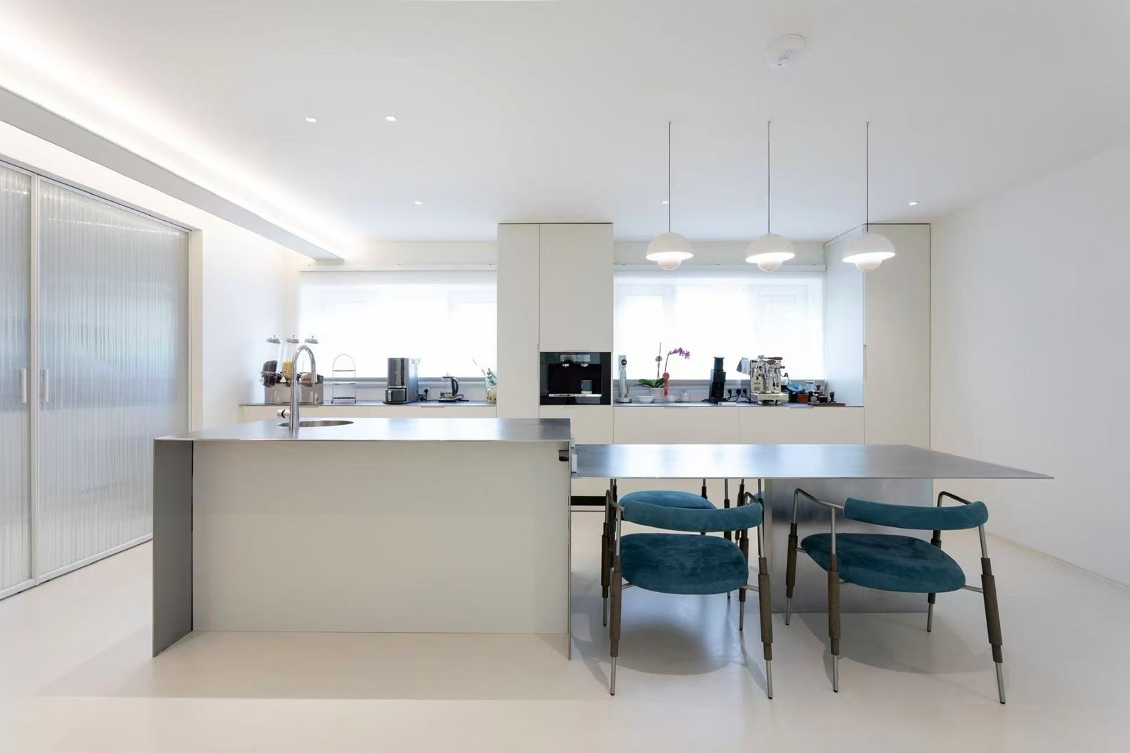 London residence kitchen with stainless island and dining area