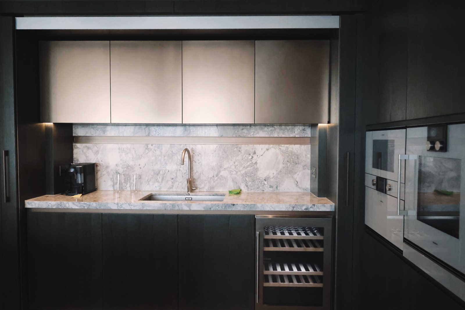 Kitchen cabinetry, marble splashback and integrated appliances